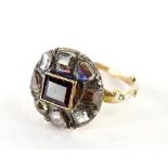 A Victorian cluster ring, with central baguette cut ruby, in gold setting, with various old cut