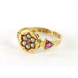 A 15ct gold dress ring, with central circular panel, set with flower and seed pearls and garnets,