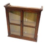 A 19thC oak wall hanging cabinet, with two glazed doors, (AF), 57cm W.
