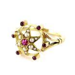 A Victorian style cluster ring, set with central star, set with garnet stones and seed pearls,