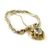 A Victorian memorial bracelet, the silver twist design bracelet with central floral carved panel