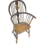 A child's Windsor chair, with a pierced splat, solid seat on turned legs, with H stretcher.