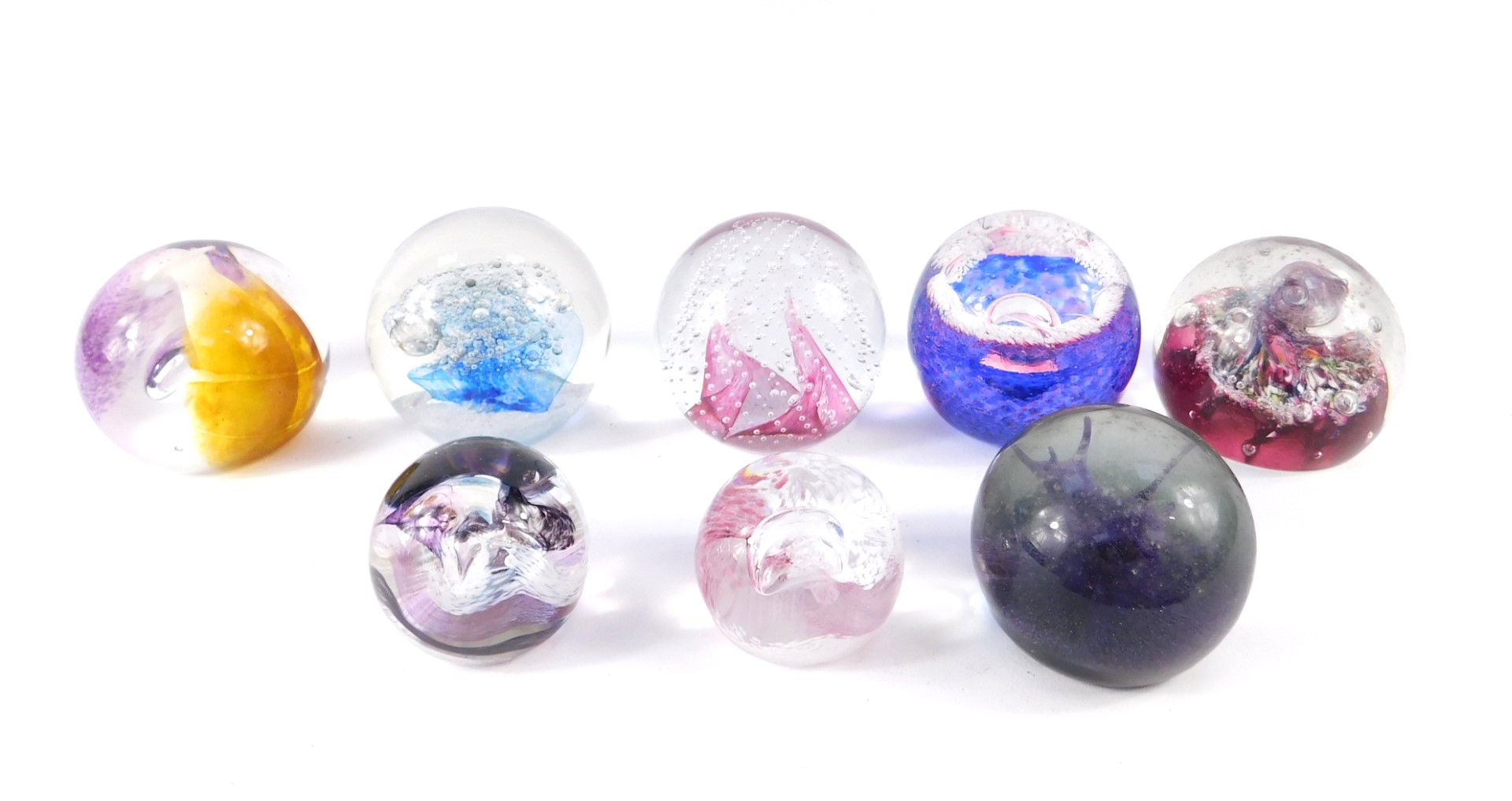 A group of Caithness glass paperweights, including Blue Splash, Cauldron Ruby, and Neon, limited