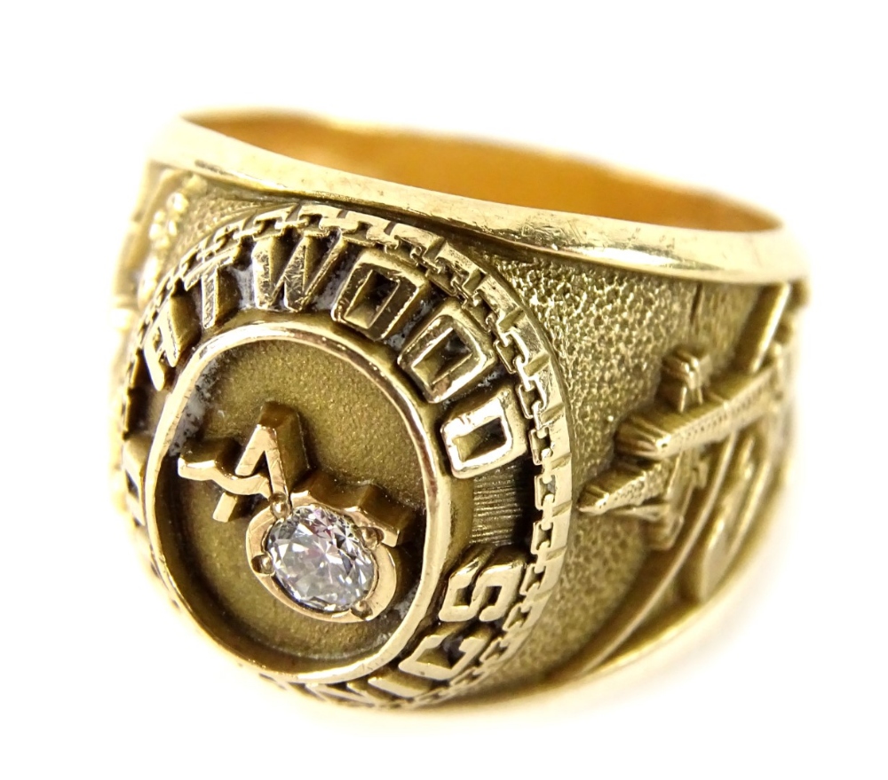 A gent's signet ring, with central raised design Atwood Oceanics and set with single diamond, the