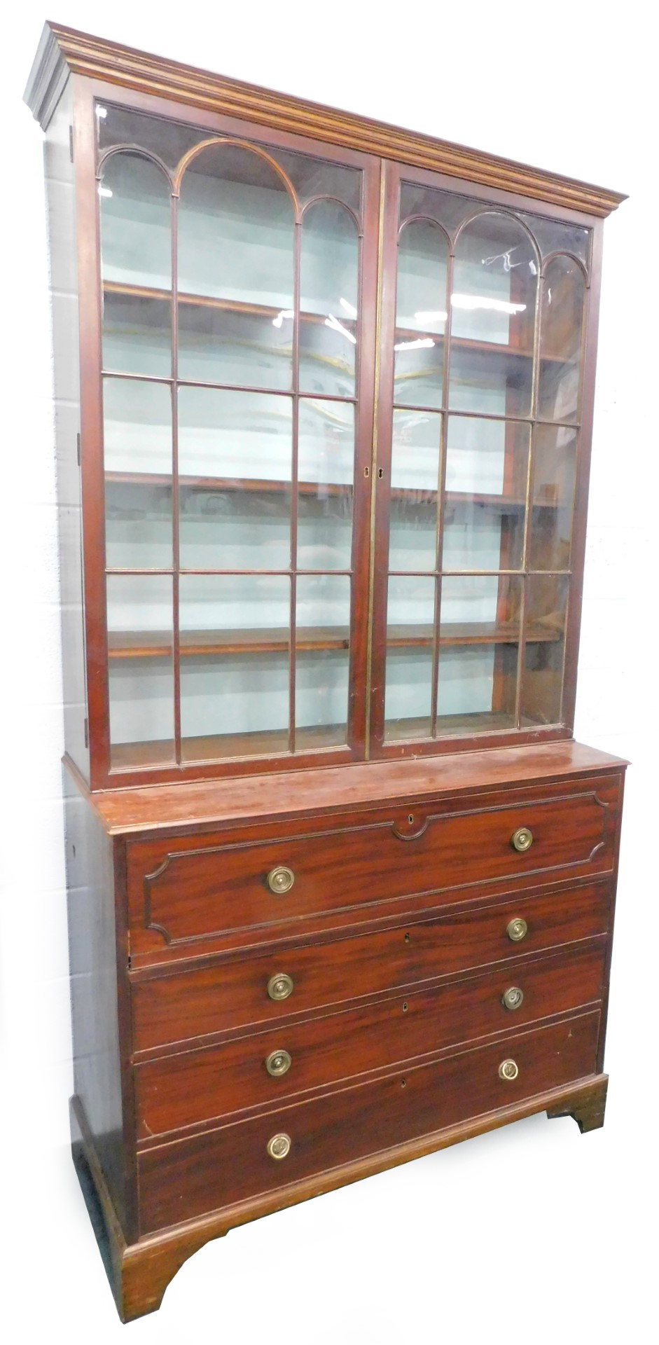 An early 19thC mahogany secretaire bookcase, the top with a moulded cornice above two astragal glaze