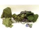 Two kits bags, together with various camouflage clothing, badges, etc.