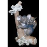 A Lladro figure group of a koala and young, on a tree branch, no. 5461, printed and impressed