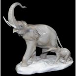 A 20thC Lladro figure of an elephant with calf, trunk raised, printed marks beneath, 31cm H.