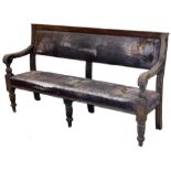 A late 19thC oak settle, with studded leather back and seat on turned legs, 100cm H, 169cm W,