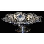 A late Victorian silver bonboniere, of octagonal pierced ebonised scroll design, raised on a