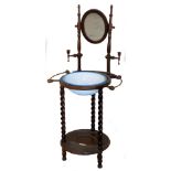 A late 19thC shaving stand, the oval mirror flanked by turned supports with a wash bowl fitted to