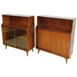 A pair of vintage stained teak open bookcases, each with an open shelf above enclosed shelves