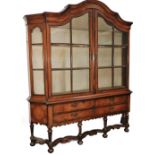 A 19thC Dutch walnut and marquetry inlaid display cabinet, the arched top profusely decorated with