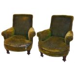 A pair of Edwardian mahogany framed armchairs, each in green material with shaped arms and deep