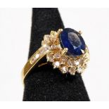 A sapphire and diamond dress ring, with central oval cut sapphire approx 2.69cts, in raised four