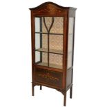 An Edwardian mahogany and boxwood strung display cabinet, the arched top raised above an astragal