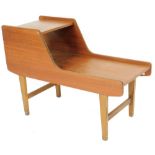 A vintage teak telephone table, of shaped form, on square tapering legs, 64cm H, 91cm W, 43cm D.