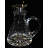 An Elizabeth II whisky tot glass jug, of tapered conical form, star cut base with silver hinged