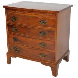 A George III style mahogany bow front bachelors chest, with brushing slide above four long