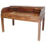 A 1920's oak tambour fronted clerks desk, with deep writing section, pigeon holes and two frieze