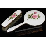 A silver backed comb, London 1961 and an enamel backed hand mirror and matching clothes brush,