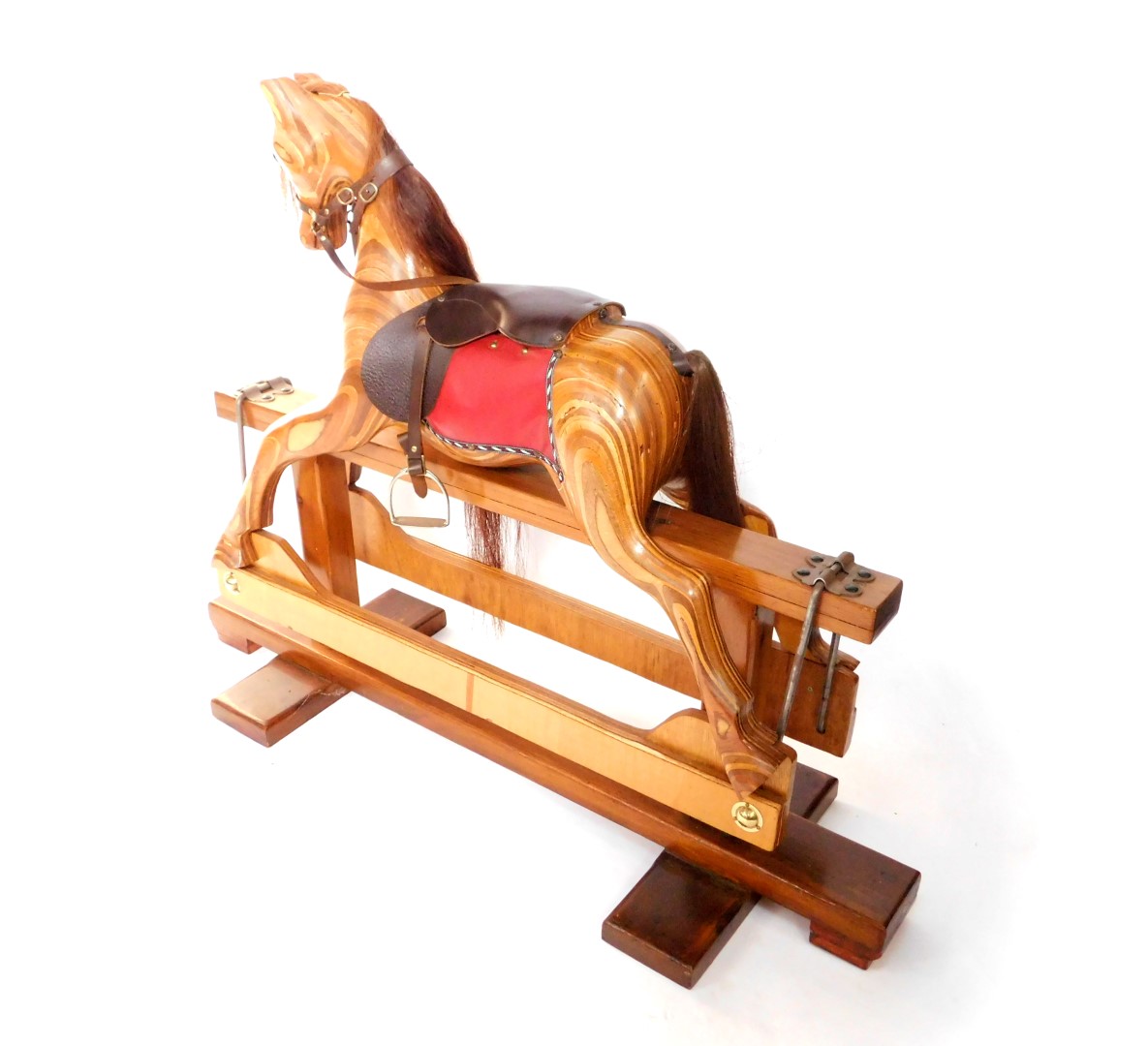 A marquetry and pine rocking horse, with red and brown leather saddle, and metal stirrups, 102cm