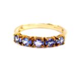 A 9ct gold and tanzanite five stone ring, size O, with certificate, 1.9g.