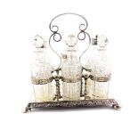 A Victorian silver plate and cut glass cruet, with three glass bottles and stoppers, two bottles