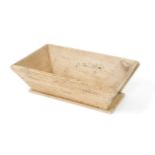 A French pine dough trough, of rectangular section with sloping sides, raised on a plinth base, 26cm