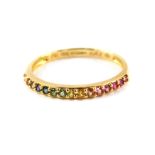 An 18ct gold and gem set half hoop eternity ring, the stones showing the colours of the rainbow,