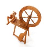 A 20thC oak spinning wheel, 86cm H, 60cm W.