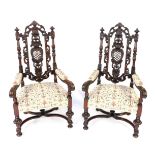 A pair of 19thC Carolean style walnut armchairs, with foliate carved crest rail and foliate and