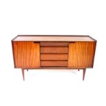 A mid 20thC teak sideboard possibly Danish, with four central graduated drawers, having horizontally