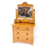 A Victorian satin walnut dressing chest, the swing frame mirror with floral carved crest rail, inset