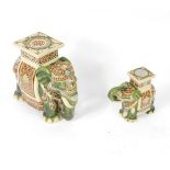 A pair of pottery graduated garden seats, modelled as elephants, 52cm W and 35cm W respectively.