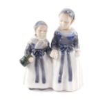 A Royal Copenhagen porcelain figure group of a pair of girls, holding hands, No 1316, printed and