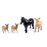 A Beswick black gloss figure of a Dale horse, Beswick standing roe deer, and two asses. (AF). (4)