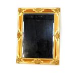 A rococo style rectangular gilt wood wall mirror, inset bevelled glass, 86cm H, 66cm W.