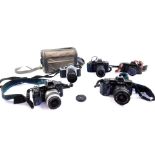 Two Minolta 7000 cameras, Canon T70 camera, Canon T50 camera, and a Asahi Pentax S1a camera. (5)