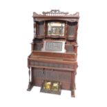 A Bell Organ & Piano Company mahogany cased pump organ, c1900, the carved pediment over six fluted