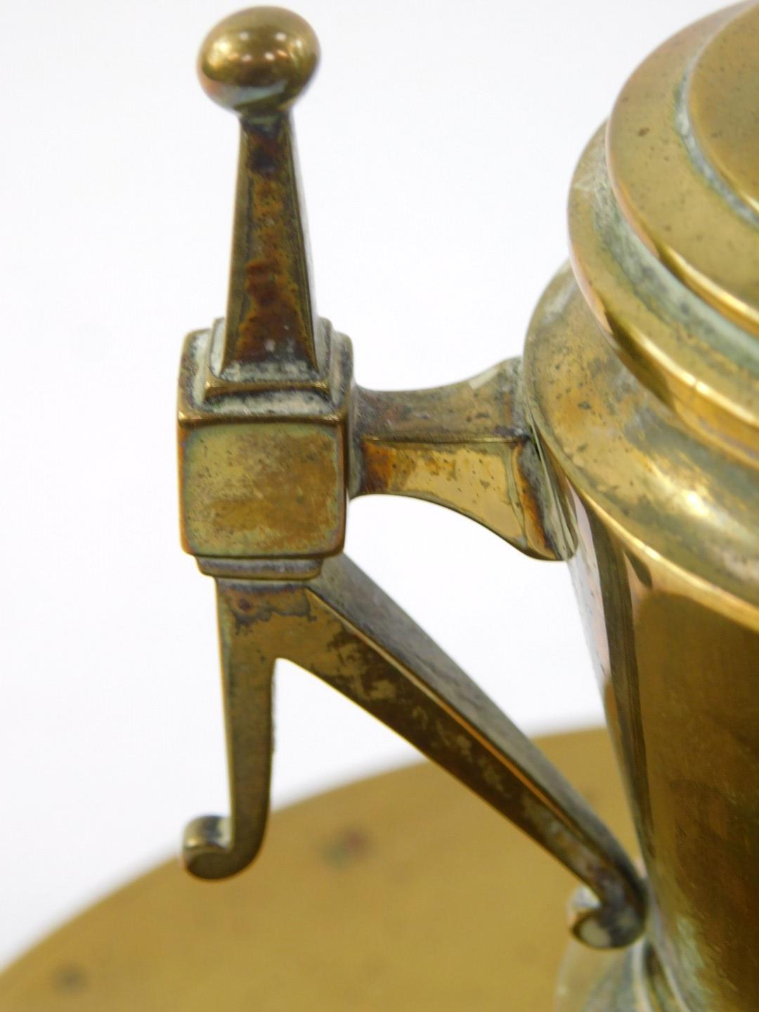 A Victorian brass ink well, of twin handled baluster vase and cover form, with ceramic liner, raised - Image 2 of 3