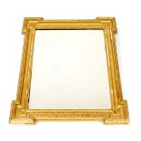 A Georgian style gilt wood and gesso wall mirrror, of rectangular section, with fluted and