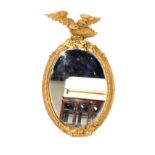 A Victorian oval gesso wall mirror, later gilt painted, with eagle surmount resting on acorns and