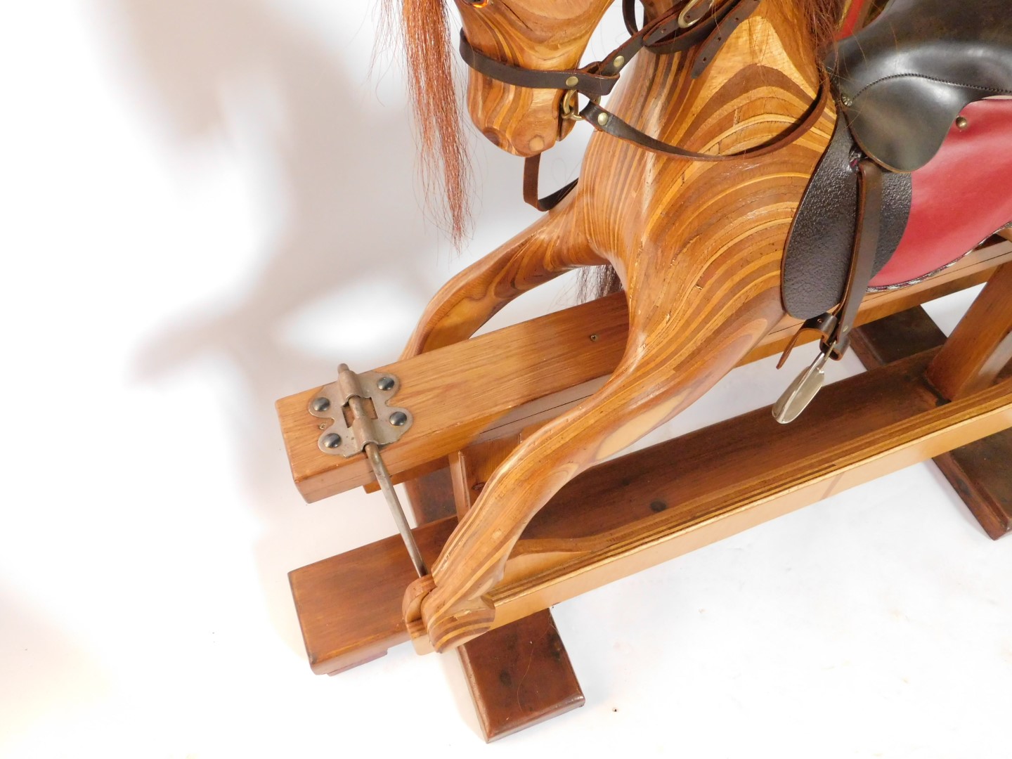 A marquetry and pine rocking horse, with red and brown leather saddle, and metal stirrups, 102cm - Image 2 of 4