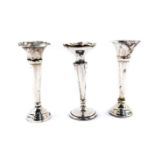 A pair of George V silver loaded bud vases, Sheffield 1916, and a further loaded silver bud vase,