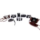 A group of cameras, including a Zorki - 4 camera, two Zeiss Ikon cameras, Edixa Wirgin camera, and a