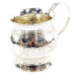 A George III silver tankard, of ogee baluster form, with fluted and engraved banded decoration,