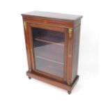 A Victorian mahogany and inlaid pier cabinet, with brass mounts, single glazed door opening to