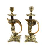 A pair of German WWI period naval sword hilt candlesticks, brass cast with wire bound grip and