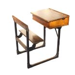 A Victorian beech and cast iron framed school desk, with an integral seat,